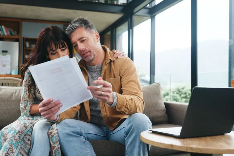 Self-employed couple at home reviewing their mortgage paperwork together