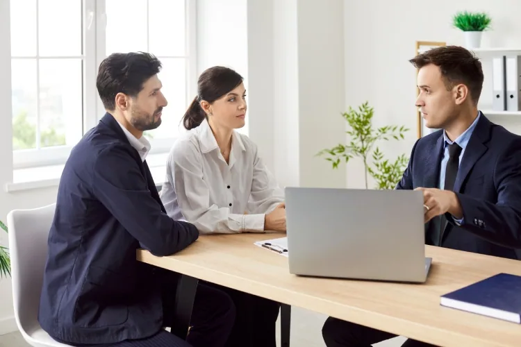 Couple meeting a mortgage broker to discuss their bank statement loan options